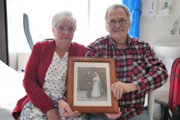 Margaret and Gary holding their wedding photo before living donor kidney transplant at Austin Hospital